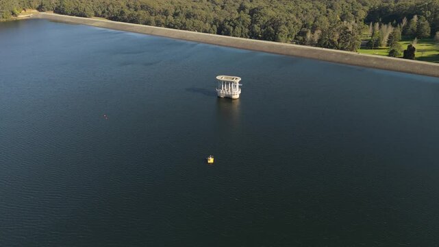 Silvan, Australia - 01 September 2026: Aerial view of the Silvan Reservoir Park with its iconic valve tower rising from the calm dark water, surrounded by lush forests in Victoria.