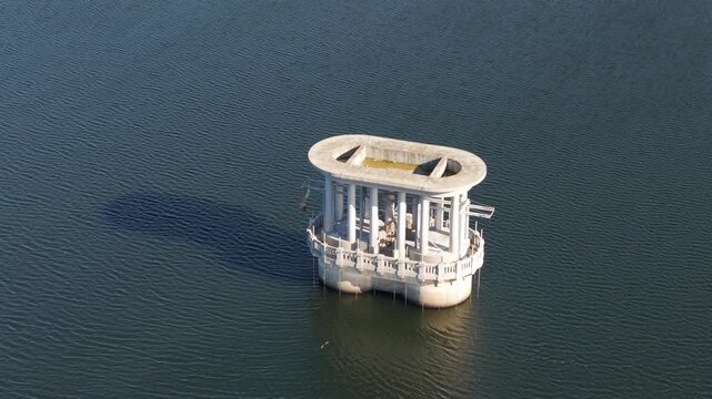 Silvan, Australia - 01 September 2026: Aerial view of the concrete intake tower structure rising from the calm waters of Silvan Reservoir.