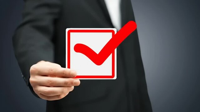 Professional hand pointing to approval checkmark on digital screen.
