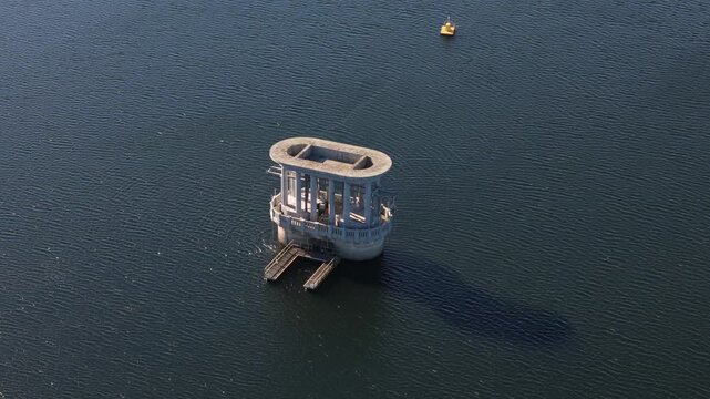 Silvan, Victoria, Australia - 01 September 2026: Aerial view of the concrete intake tower structure situated in the middle of the Silvan Reservoir.
