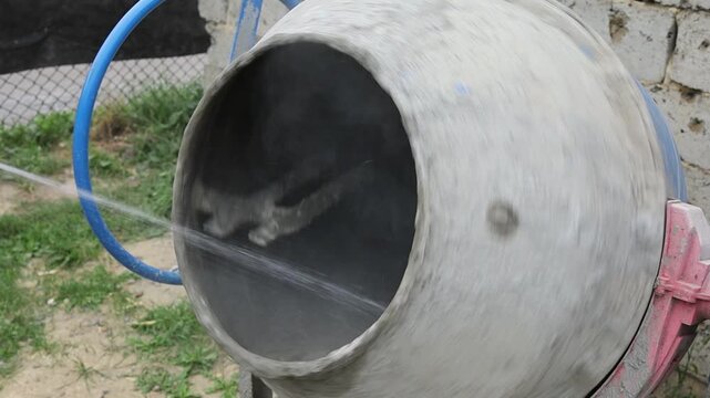 Cleaning a concrete mixer with a hose