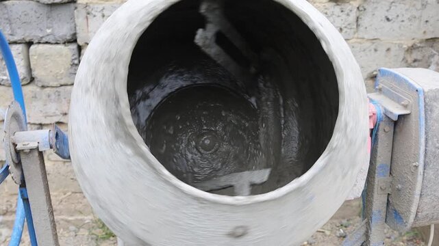 Mixing cement in a drum for construction tasks