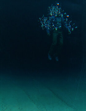 Middle aged man in casual wardrobe under water in ocean. 3D rendered still image.