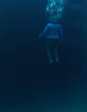 Middle aged man in casual wardrobe under water in ocean. 3D rendered still image.