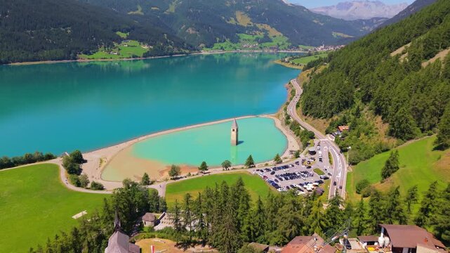 Aerial view of the iconic submerged church tower of Curon Lake Resia, in South Tyrol, Italy