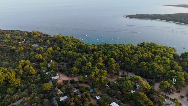 FKK Naturist Baldarin Campsite In Punta Kriza On Cres Island, Croatia, Aerial Drone Shot A Beautiful Summer Evening. Campervans, Motorhomes, Coastal Nature, Crystal Clear Adriatic Sea, Scenic Bays