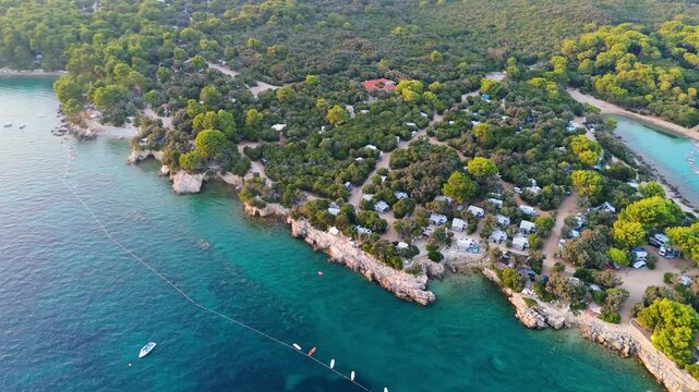 FKK Naturist Baldarin Campsite In Punta Kriza On Cres Island, Croatia, Aerial Drone Shot A Beautiful Summer Evening. Campervans, Motorhomes, Coastal Nature, Crystal Clear Adriatic Sea, Scenic Bays