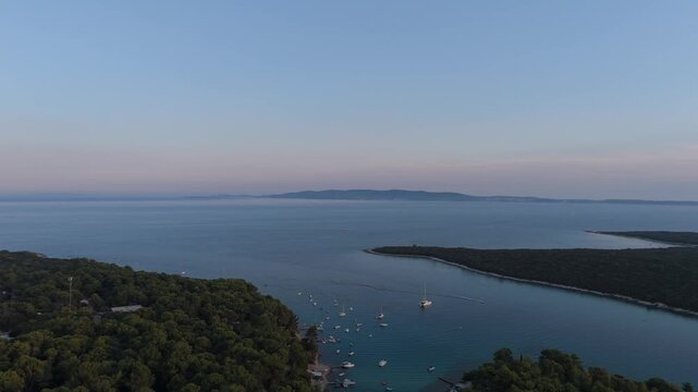 FKK Naturist Baldarin Campsite In Punta Kriza On Cres Island, Croatia, Aerial Drone Shot A Beautiful Summer Evening. Campervans, Motorhomes, Coastal Nature, Crystal Clear Adriatic Sea, Scenic Bays
