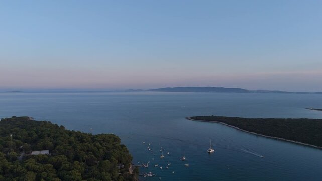 FKK Naturist Baldarin Campsite In Punta Kriza On Cres Island, Croatia, Aerial Drone Shot A Beautiful Summer Evening. Campervans, Motorhomes, Coastal Nature, Crystal Clear Adriatic Sea, Scenic Bays