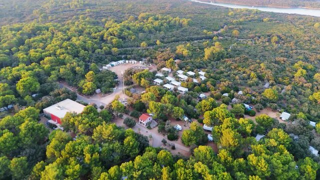 FKK Naturist Baldarin Campsite In Punta Kriza On Cres Island, Croatia, Aerial Drone Shot A Beautiful Summer Evening. Campervans, Motorhomes, Coastal Nature, Crystal Clear Adriatic Sea, Scenic Bays