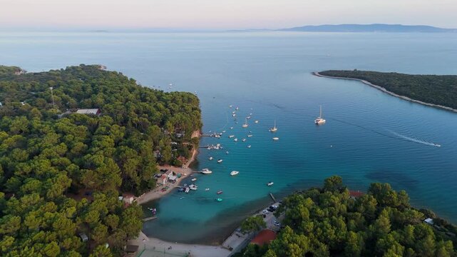 FKK Naturist Baldarin Campsite In Punta Kriza On Cres Island, Croatia, Aerial Drone Shot A Beautiful Summer Evening. Campervans, Motorhomes, Coastal Nature, Crystal Clear Adriatic Sea, Scenic Bays