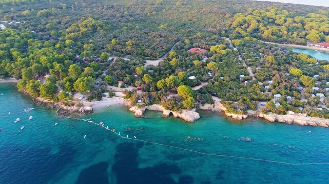 FKK Naturist Baldarin Campsite In Punta Kriza On Cres Island, Croatia, Aerial Drone Shot A Beautiful Summer Evening. Campervans, Motorhomes, Coastal Nature, Crystal Clear Adriatic Sea, Scenic Bays