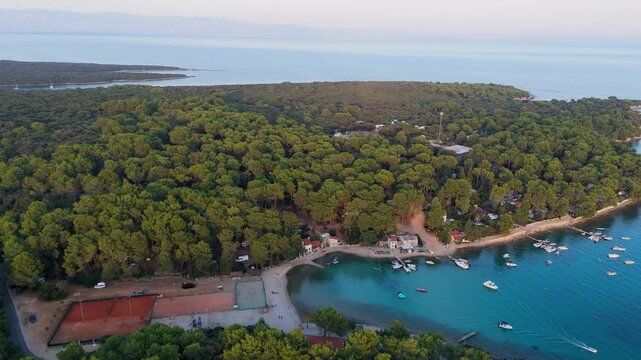 FKK Naturist Baldarin Campsite In Punta Kriza On Cres Island, Croatia, Aerial Drone Shot A Beautiful Summer Evening. Campervans, Motorhomes, Coastal Nature, Crystal Clear Adriatic Sea, Scenic Bays
