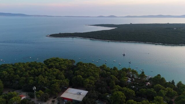 FKK Naturist Baldarin Campsite In Punta Kriza On Cres Island, Croatia, Aerial Drone Shot A Beautiful Summer Evening. Campervans, Motorhomes, Coastal Nature, Crystal Clear Adriatic Sea, Scenic Bays