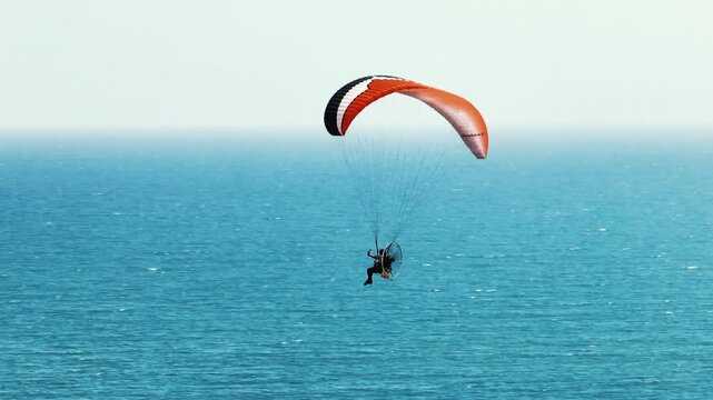 Aerial Telephoto Shot of Paraglider Flying Over Atlantic Ocean in Namibia