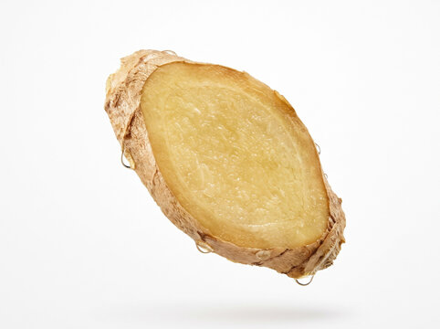 Fresh raw ginger root slice with water drops on white background