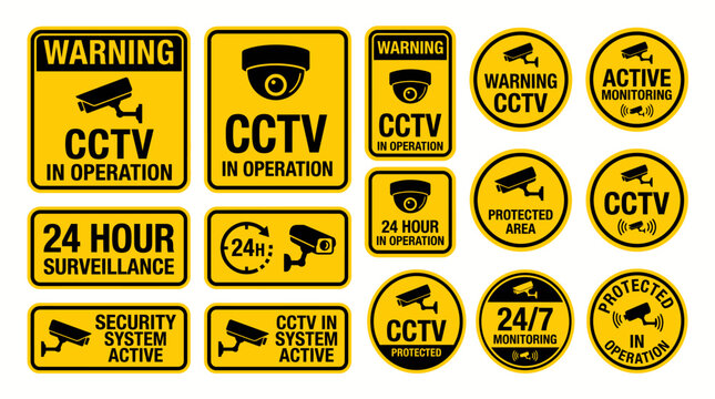 Collection of CCTV warning stickers with camera icons and text about 24 hour surveillance operations. Yellow rectangular and circular signage for security systems. Safety protection labels