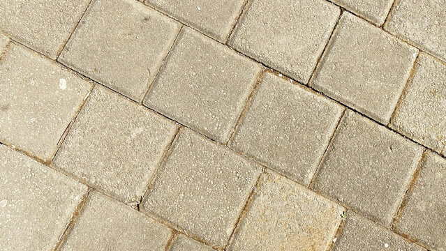Diagonal beige square concrete paving blocks seamless pattern background