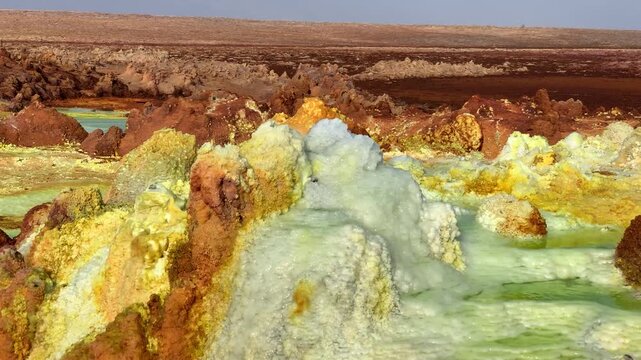 View of the colorful Dallol hydrothermal field with vibrant mineral deposits and acidic pools in the volcanic landscape of Ethiopia.