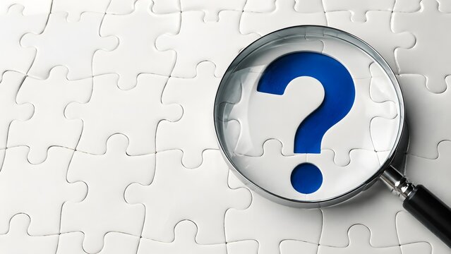 Magnifying glass revealing a blue question mark hidden inside a white jigsaw puzzle representing problem solving and strategic investigation