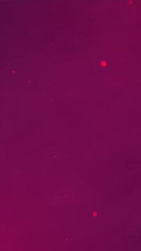 Animation of falling glowing red light spots on dark red smoke background