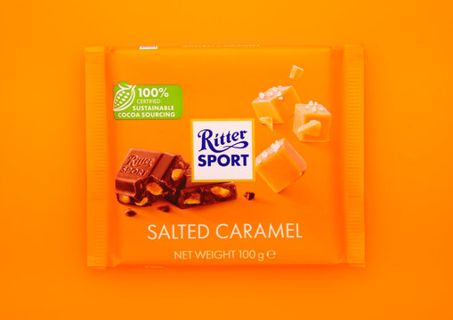 LONDON, UK - NFEBRUARY 27, 2025: Ritter Sport chocolate bar with salted caramel on orange background.