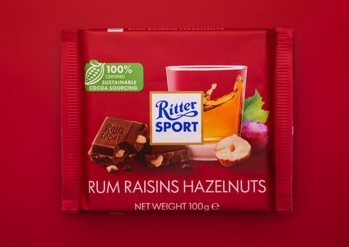 LONDON, UK - FEBRUARY 28, 2025: Rum raisin hazelnut chocolate bar by Ritter Sport on red background.