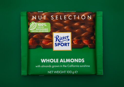LONDON, UK - FEBRUARY 24, 2025: Chocolate bar by Ritter Sport with whole almonds on green background.