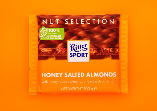 LONDON, UK - JANUARY 27, 2025: Ritter Sport chocolate bar with honey salted almonds on orange background.