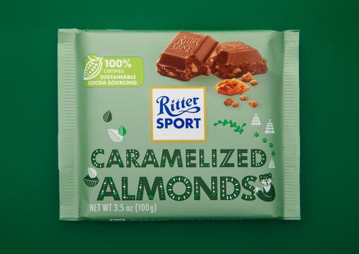 LONDON, UK - FEBRUARY 05, 2025: Ritter Sport chocolate bar with caramelized almonds and mlk chocolate on green background.