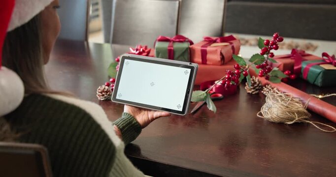 On frame start hands are tilting and shifting tablet over gift table to center screen