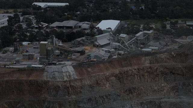 Montrose, Victoria, Australia - 28 August 2026: Aerial view of Boral Montrose quarry featuring industrial processing facilities, conveyor belts, and deep excavation pits.