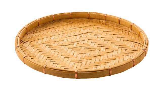 Traditional round woven bamboo winnowing tray basket isolated on black background