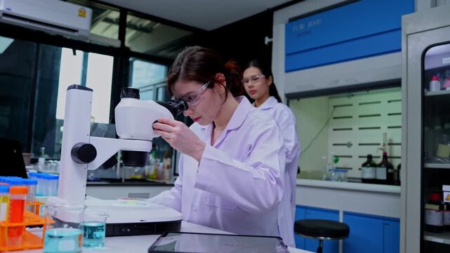 Dedicated female scientist analyzing samples in a modern laboratory setting with advanced technology