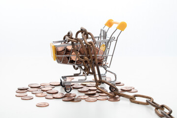 Chained shopping cart with coins symbolizing debt and financial restriction © PhamHong