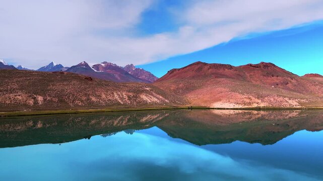 Stunning Aerial Landscape of Chandratal Lake in Spiti Valley, Himachal Pradesh with Deep Blue Turquoise Water, Rocky Himalayan Mountains and Bright Sunny Skies