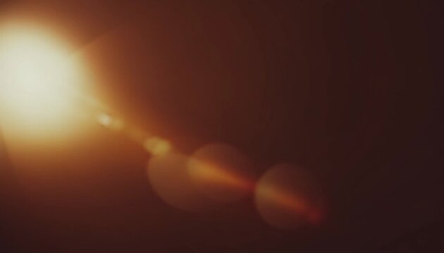 Warm lens flare and light leak background with soft bokeh glow and dark brown tones, cinematic abstract texture for photography, posters, overlays and digital design.