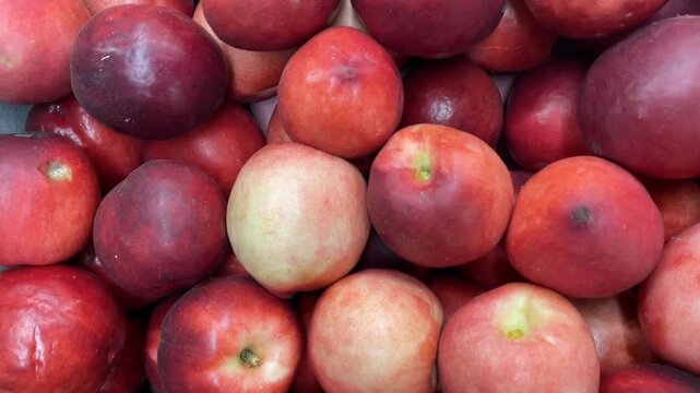Red and white apples piled together creating a colorful and fresh fruit background