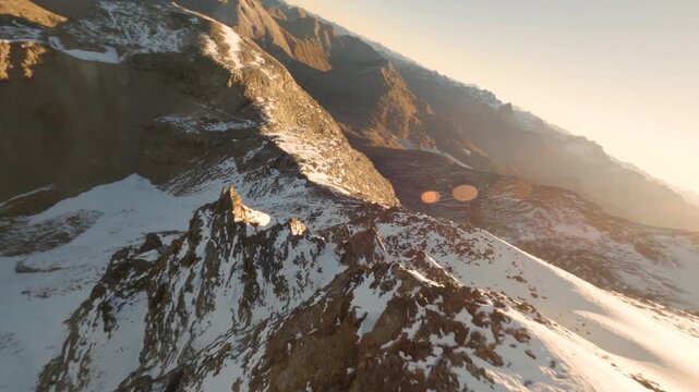 FPV aerial view of snowy mountain peaks in the Swiss Alps, Meggen, Luzern, Switzerland.