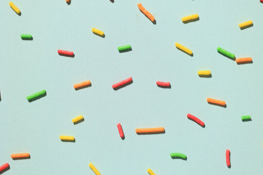 Colorful Candy Sugar Sprinkle on Mint Background