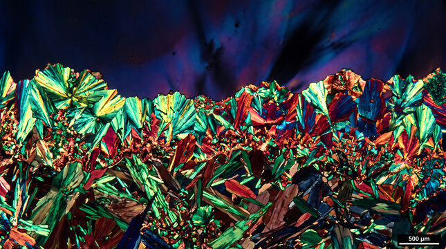 Microscopic View of Vibrant Iridescent Crystals under Polarized Light, 500 Micron Scale
