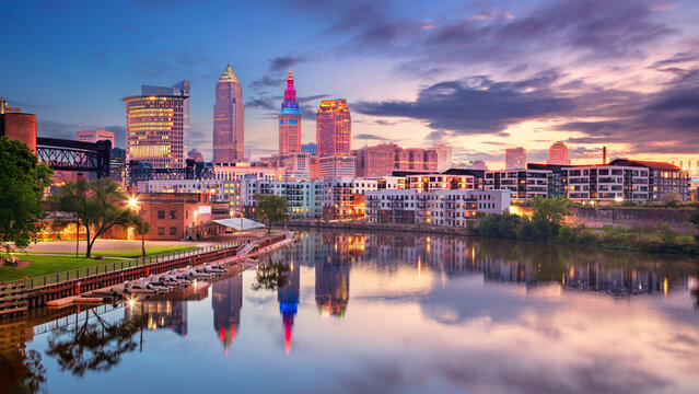 Cleveland, Ohio, USA. Panoramic cityscape image of Cleveland, Ohio with reflection of the city skyline in the water at beautiful sunrise.