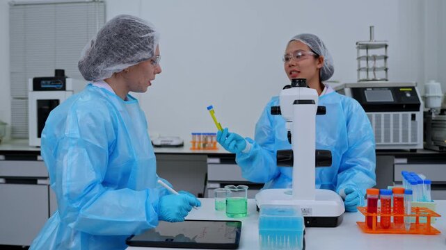 Scientists in laboratory analyzing samples with advanced technology and equipment for medical research