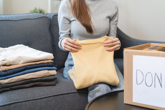 Organize closet and storage concept, people prepare unwanted old fashion clothes for share donation.