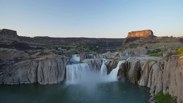 View of Shoshone Falls with cascading water over rocky cliffs and river below in Twin Falls County, Idaho, United States.