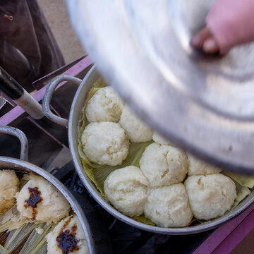 Traditional otongo being served from a cooking pot in the Peruvian Andes. Handmade oca specialty is steamed on corn husks in a local preparation.
