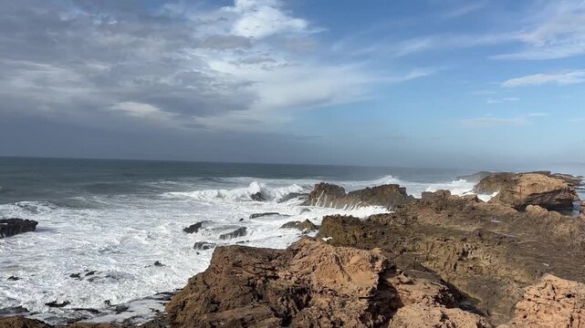 Waves crashing against the rocky coast below the fortress of Essaouira in Morocco, Africa
