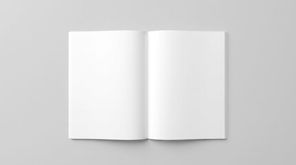 Fototapeta premium Mockup of an open blank magazine or book with clean white pages lying on a neutral gray surface, top view for editorial presentation