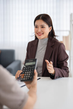 Financial advisors, real estate agents, insurance, retirement fund management concepts. Financial advisors present document plans to seniors planning for retirement.