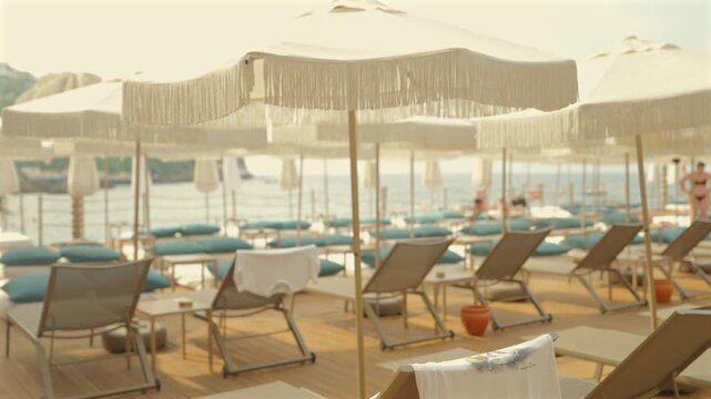 Sunlit Resort Terrace with Fringe Umbrellas and Sea View